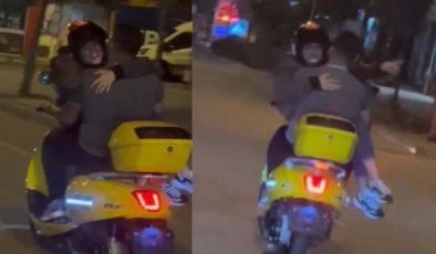 Trafikte tehlikeli hareketler: Kız arkadaşını kucağında taşıdı